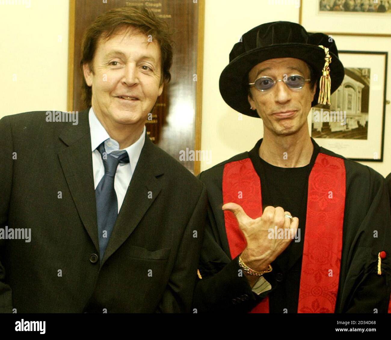 Sir Paul McCartney (left) poses with Bee Gee Robin Gibb after he had honorary degree conferred on him. Stock Photo
