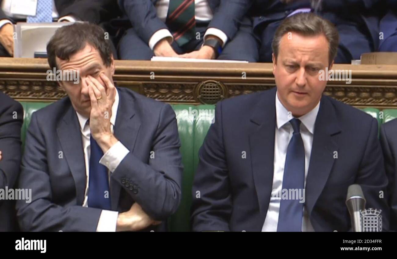 Chancellor George Osborne and Prime Minister David Cameron listens as Labour leader Jeremy Corbyn responds after the PM made a statement to MPs in the House of Commons, London following the vote in the EU referendum. Stock Photo