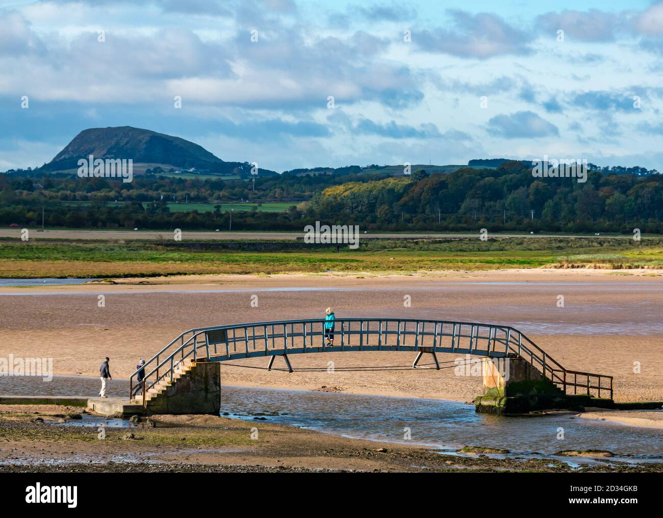 Belhaven, East Lothian, Scotland, United Kingdom, 7th October 2020. UK Weather: sunshine on the Bridge to Nowhere. The bridge over the Biel Water is only accessible at low tide for visitors to the beach at Belhaven Bay with Traprain Law in the distance Stock Photo