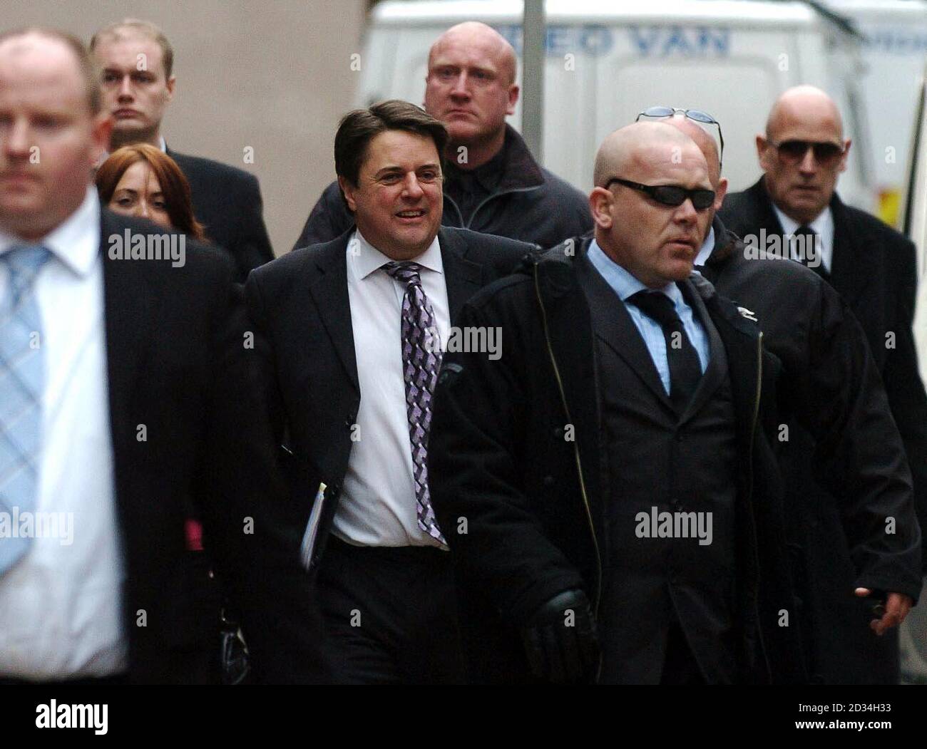 British National Party (BNP) leader Nick Griffin (centre) arrives at Leeds Crown Court, Wednesday February 1, 2006, where the jury is expected to be sent out to consider its verdicts today in his trial on race hate charges. Griffin, 46, and fellow party activist Mark Collett, 24, both deny using words intended to stir up racial hatred when they made a series of speeches in 2004. See PA story COURTS BNP. PRESS ASSOCIATION photo. Photo credit should read: John Giles/PA. Stock Photo