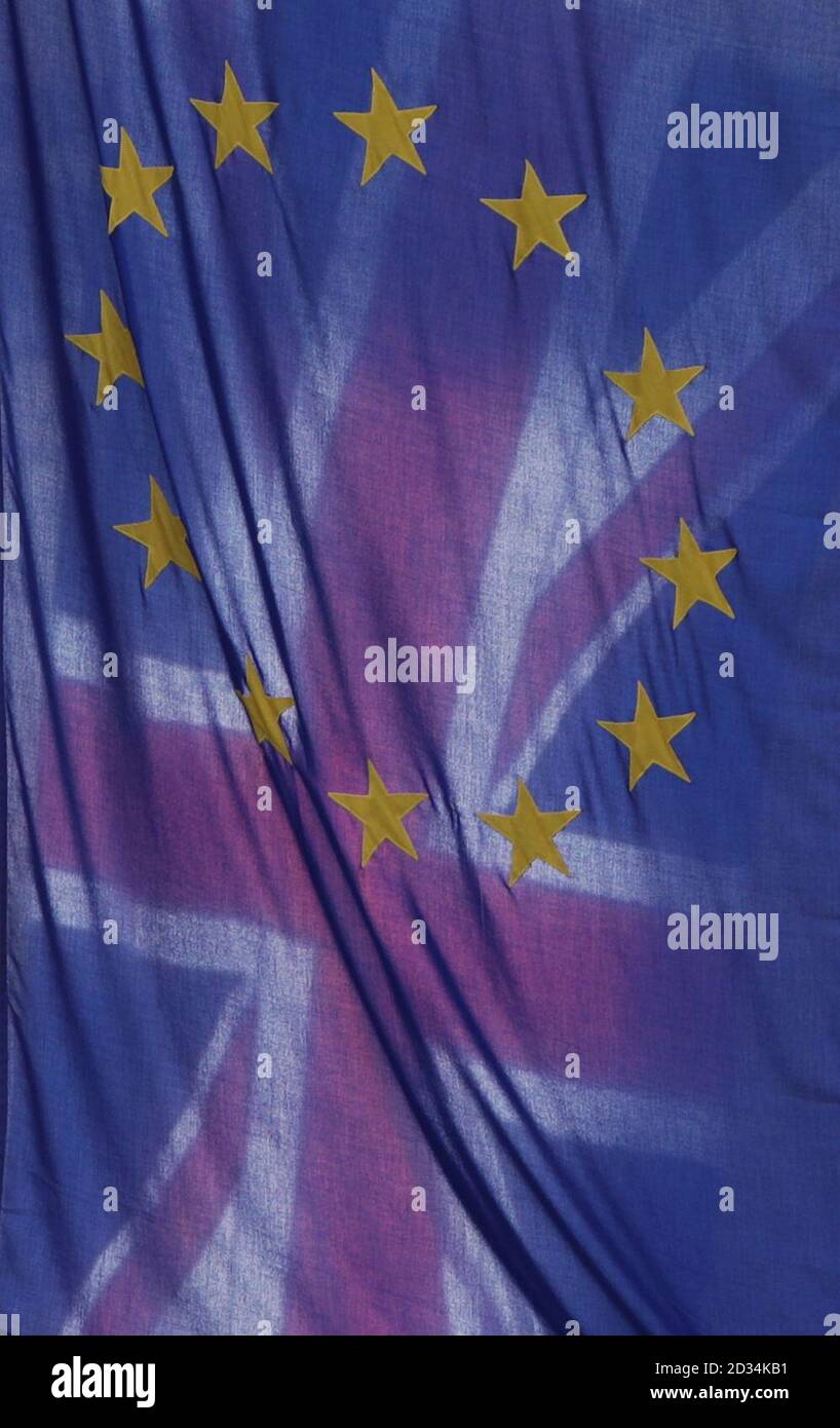 A view of the Union Jack behind the EU flag hanging outside Europe House in Smith Square, London. A row over the Brexit divorce bill has dominated the latest round of talks between the UK and the European Union, with both sides in the Brussels negotiations voicing their frustrations. Stock Photo