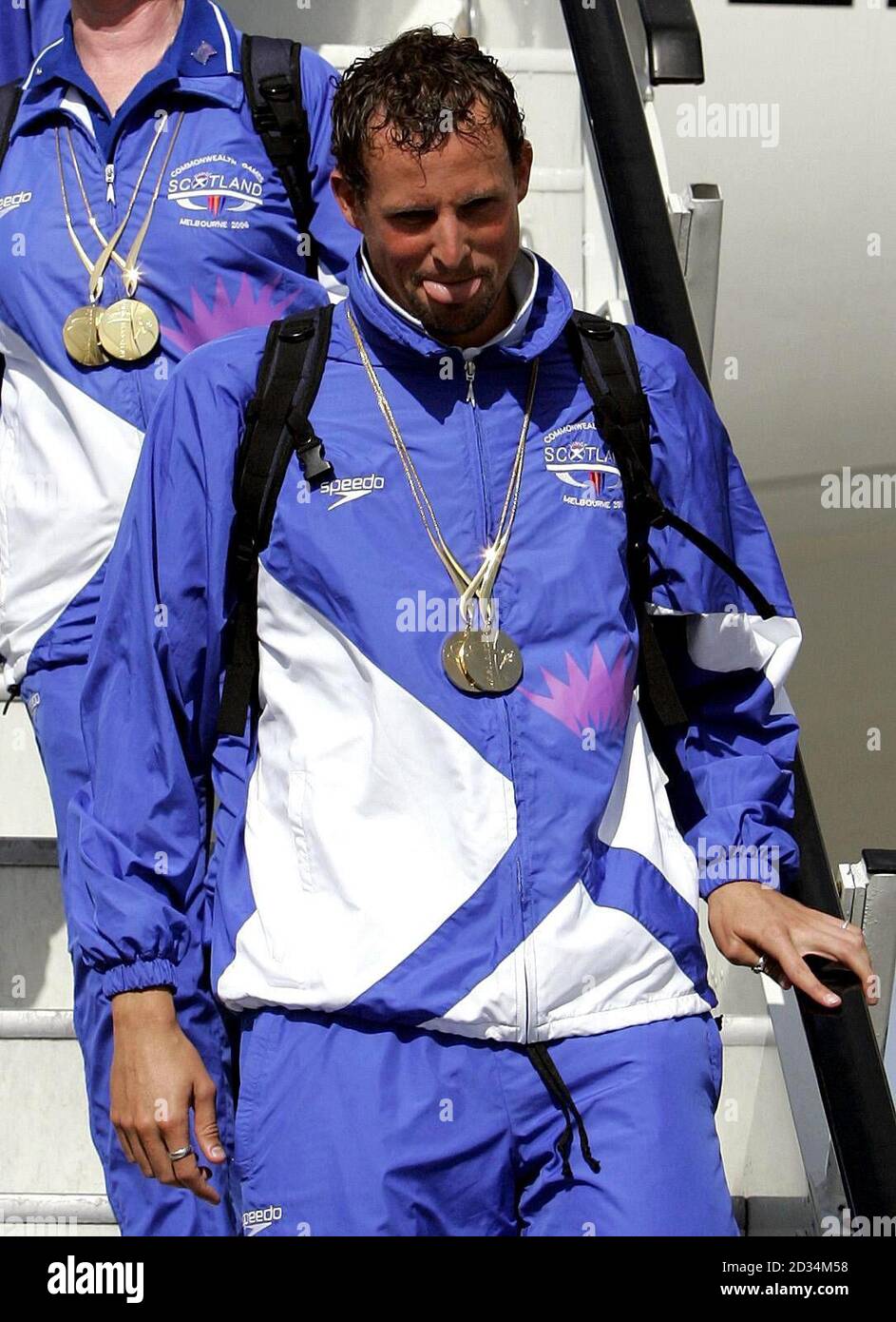 Scotland's swimmer Gregor Tait with his two gold medals on arrival at Glasgow Airport, Wednesday March 29, 2006. The Scotland team returned home from the Commonwealth Games which were held in Melbourne, Australia last week. Watch for PA story. PRESS ASSOCIATION Photo. Photo credit should read: Andrew Milligan/PA. Stock Photo