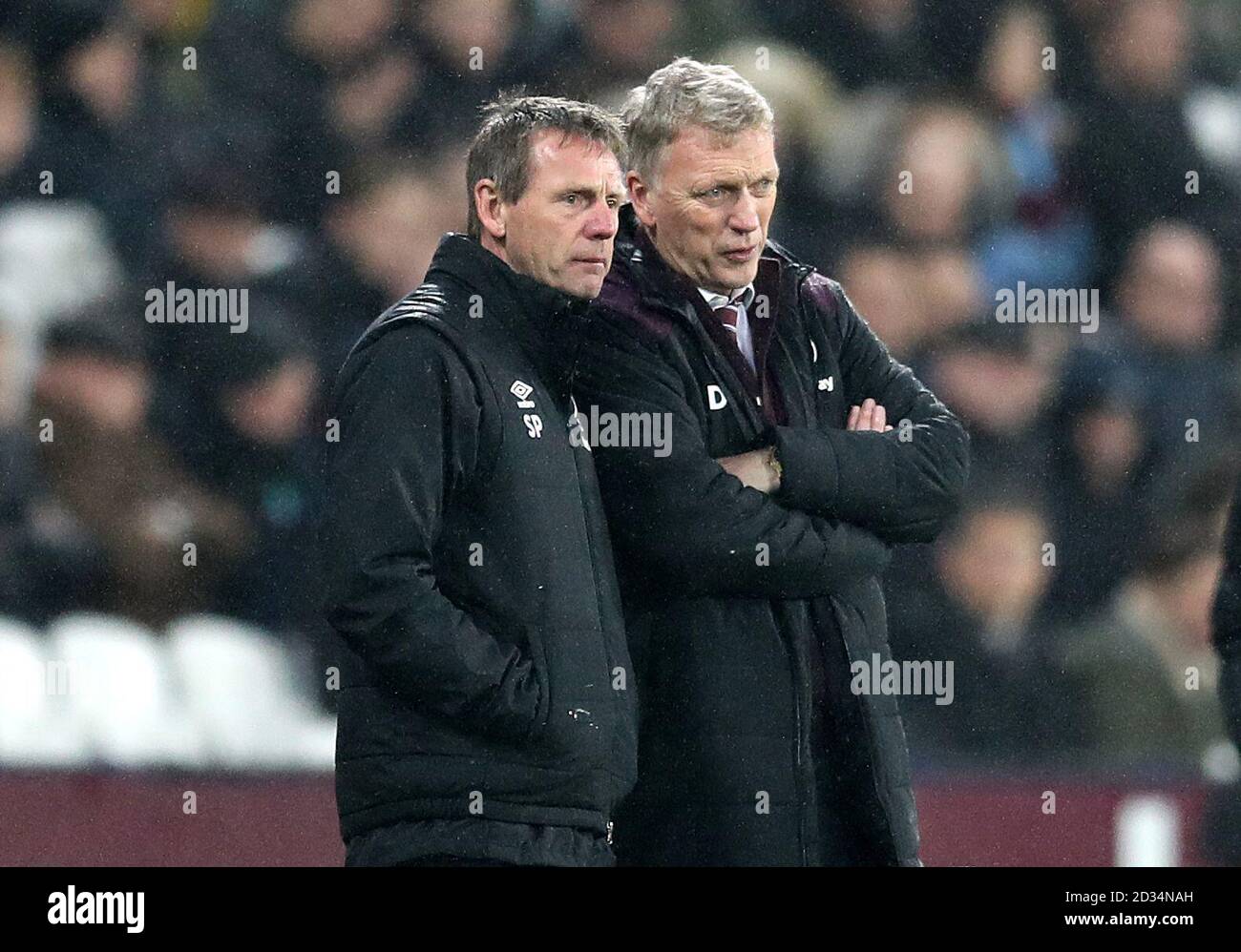 West Ham United manager David Moyes (right) and assistant manager Stuart Pearce (left) during the Premier League match at the London Stadium, London. Stock Photo