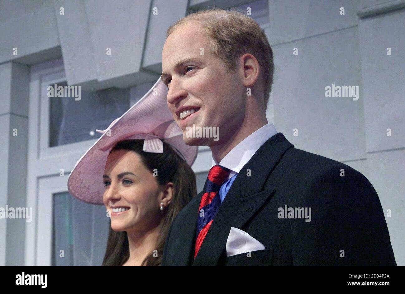 Wax figures of the Duke and Duchess of Cambridge standing on a newly-unveiled set recreating the Buckingham Palace balcony at Madame Tussauds in London. Visitors to the attraction will be able to step on to the balcony and pose with the royal family. Stock Photo
