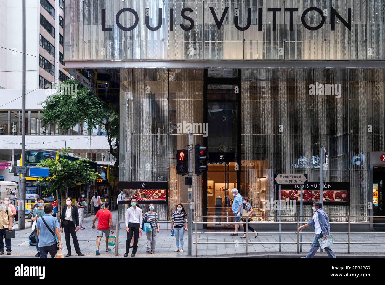 Pedestrians are seen in front of a French luxury fashion brand Louis Vuitton  (LV) store in Hong Kong. (Photo by Budrul Chukrut / SOPA Images/Sipa USA  Stock Photo - Alamy