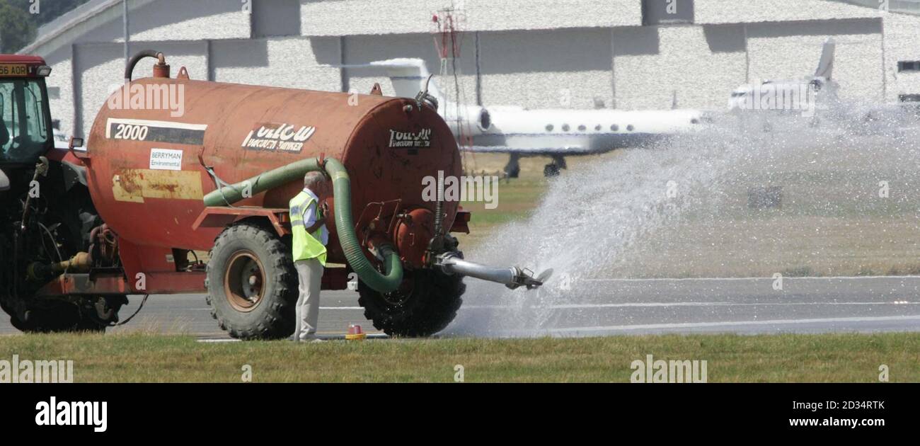 The runway is cooled at the Farnborough International Airshow in Hampshire. Stock Photo