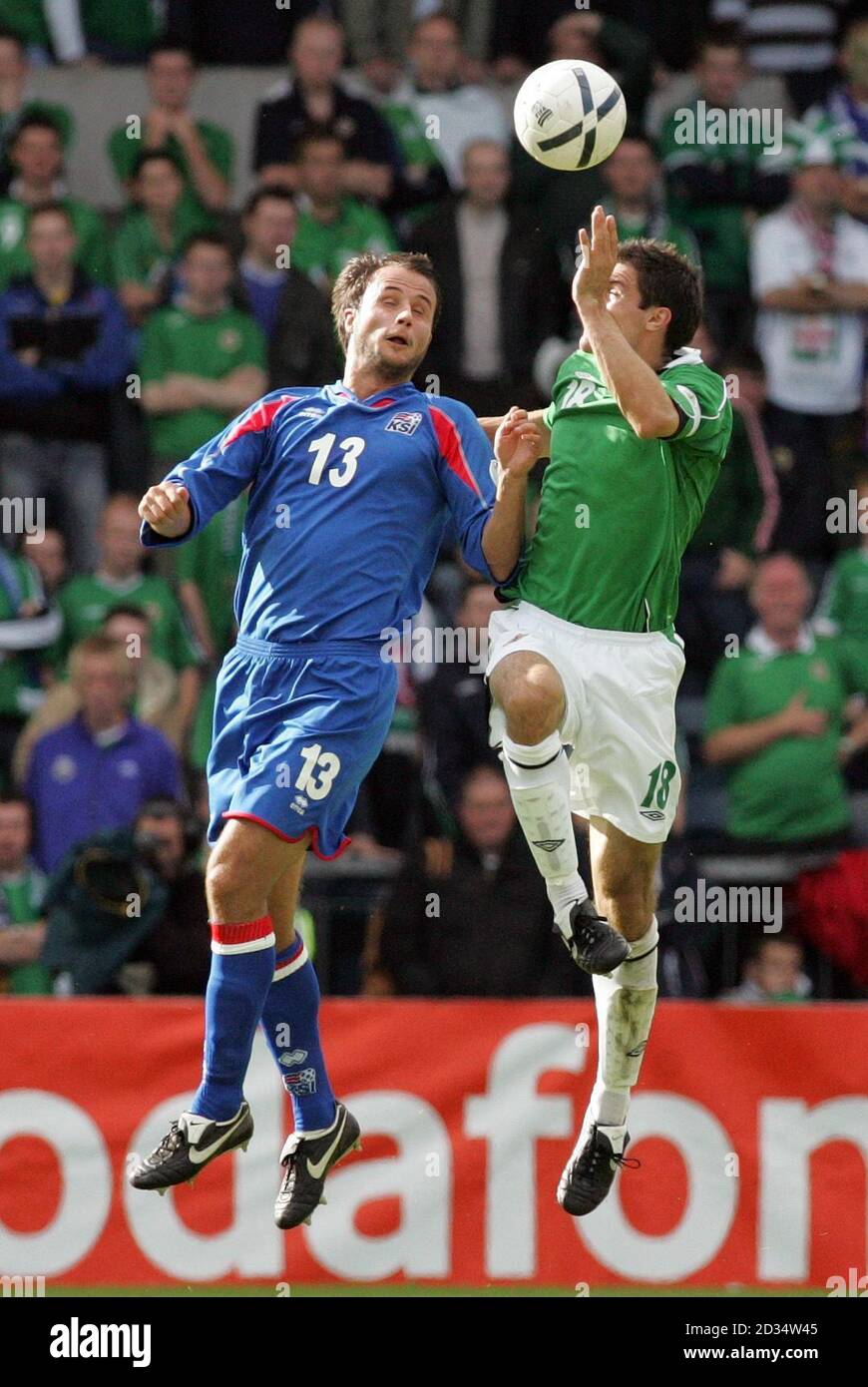 Northern Ireland's captain Aaron Hughes (right) clashes heavily with Iceland's Helgi Valur Danielsson during the European Championship qualifying match at Windsor Park, Belfast. Stock Photo