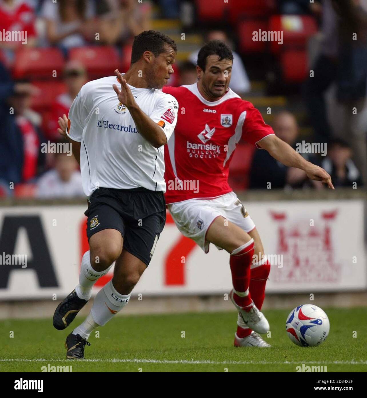 Luton Town's, Lewis Emanuel and Barnsley's Martin Devaney, battle for the ball during the Coca-Cola Championship match at the Oakwell Ground, Barnsley. Stock Photo
