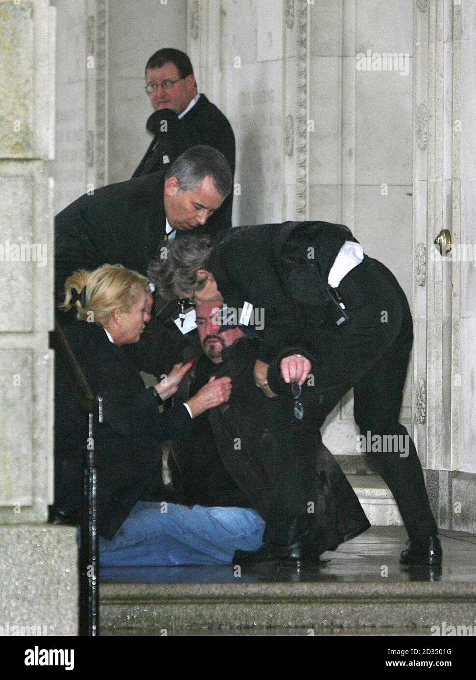 Michael Stone being restrained be security staff after forcing the  suspension of the Stormont Assembly today after claiming he had thrown a  bomb into Parliament Buildings Stock Photo - Alamy