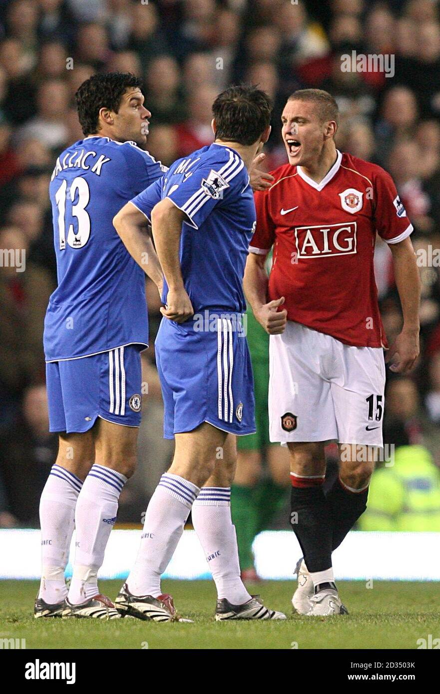 Manchester United's Nemanja Vidic (r) takes exception to a challenge by Chelsea's Michael Ballack (l). Stock Photo