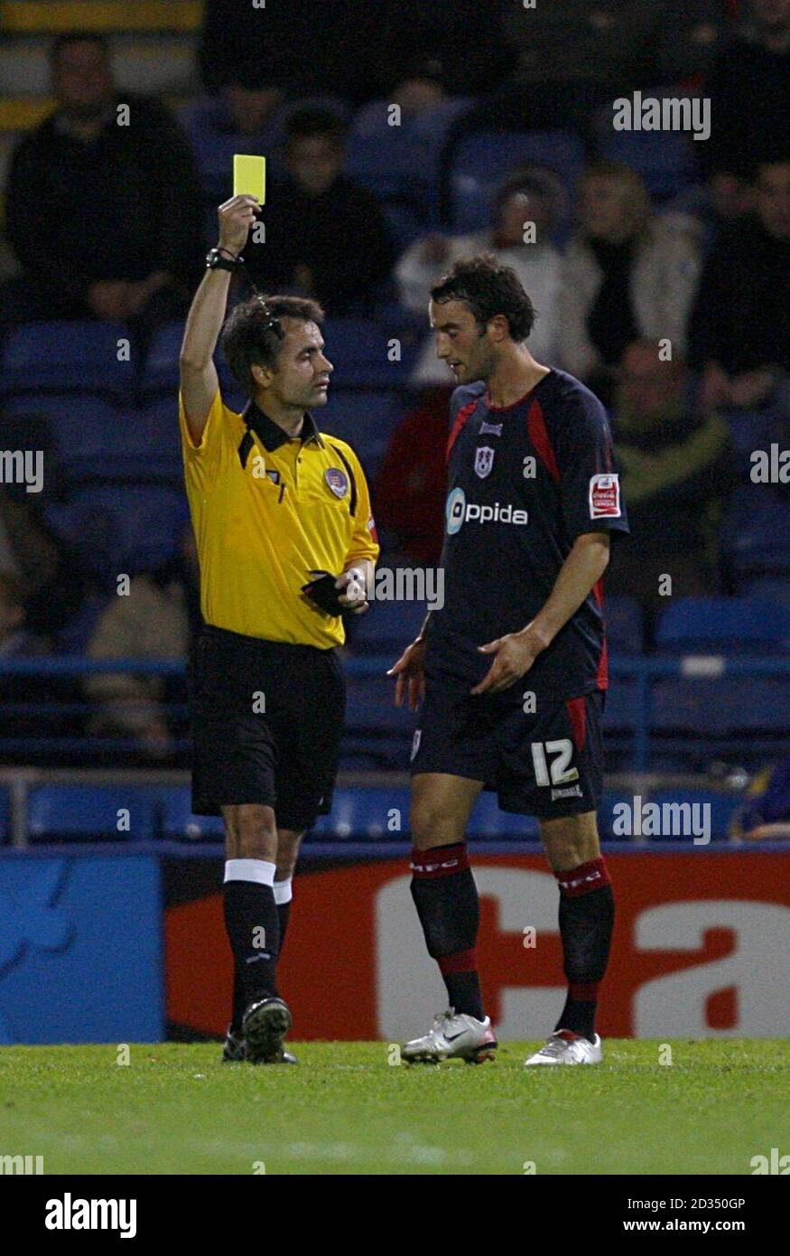 Millwall's Chris Hackett is shown a yellow card by the referee for his tackle on Justine Gregory Stock Photo