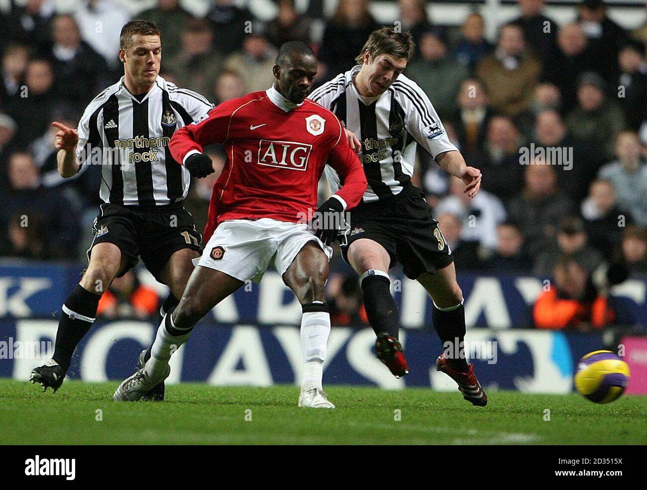 Newcastle United's Scott Parker (left) and Paul Huntington battle with Manchester United's Louis Saha (centre) during the Barclays Premiership match at St James Park, Newcastle. Stock Photo