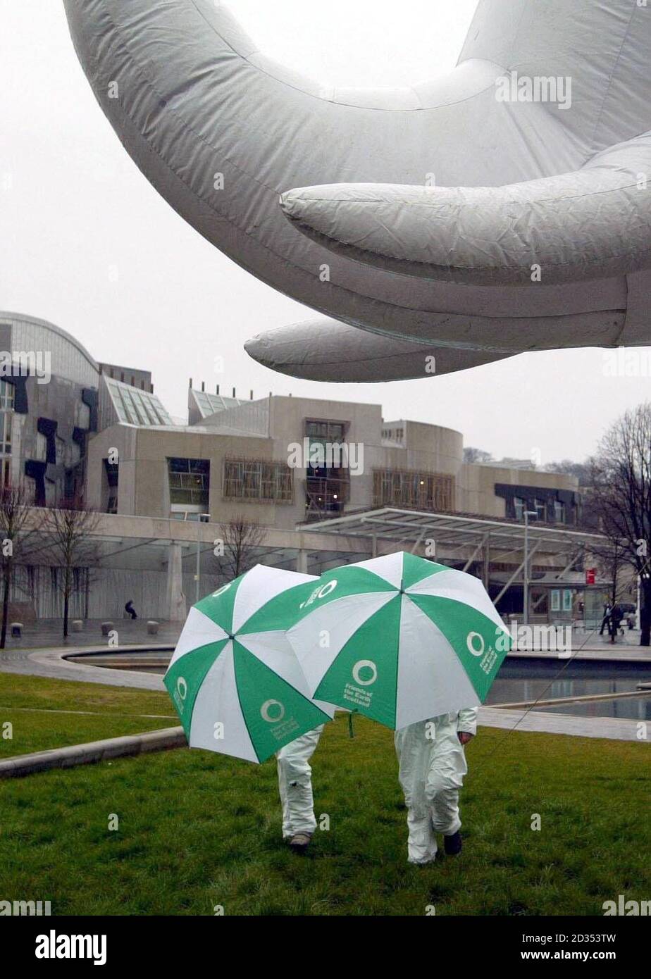Friends of the Earth Scotland activists demonstrate outside the Scottish Parliament building in Edinburgh with an inflatable elephant in a bid to get MSPs to rule out the 'white elephant' of new nuclear power in their manifestos. Stock Photo