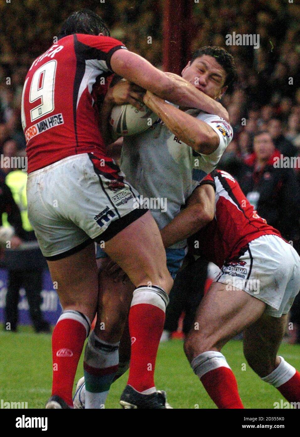Harlequins' Tyrone Smith is tackled by Salford Reds' Stuart Littler (left) during the engage Super League match at The Willows, Salford. Stock Photo
