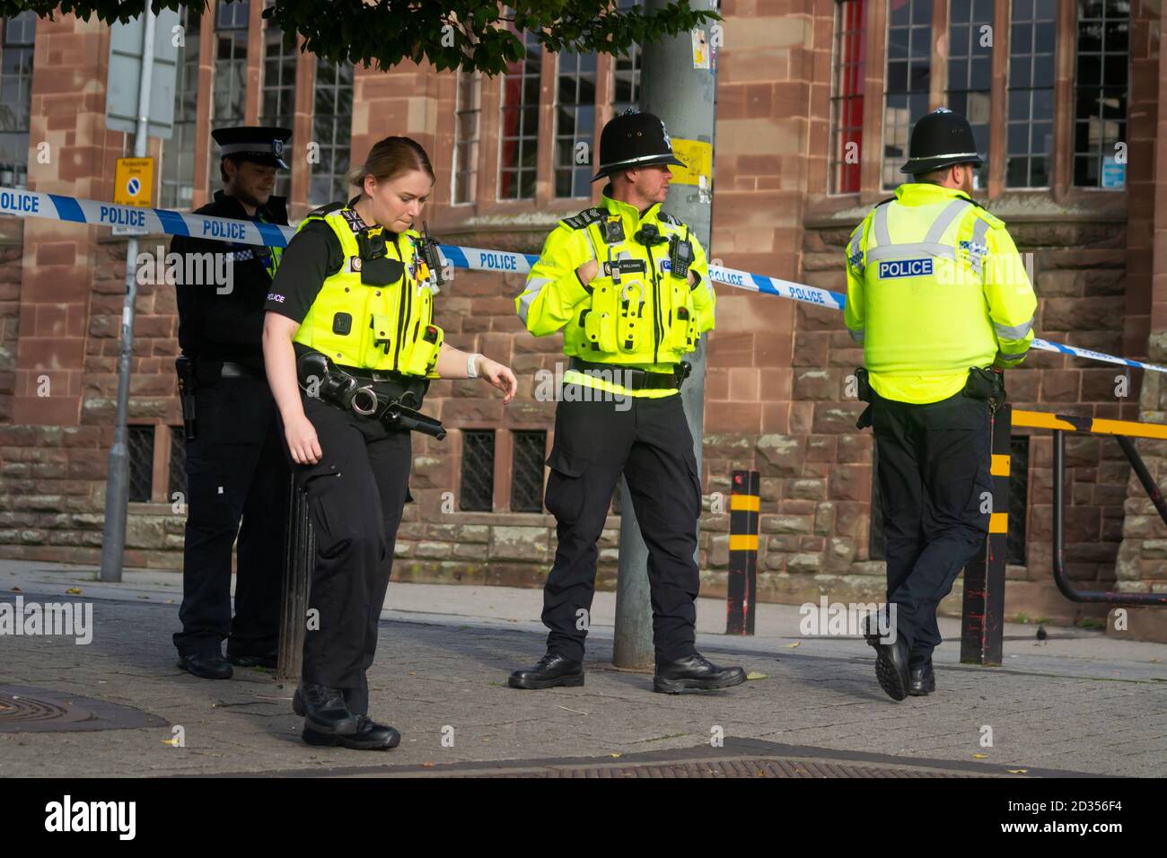 West Midlands Police officers at the cordon of a serious assault in Birmingham City Centre Bull Ring outdoor Markets Stock Photo