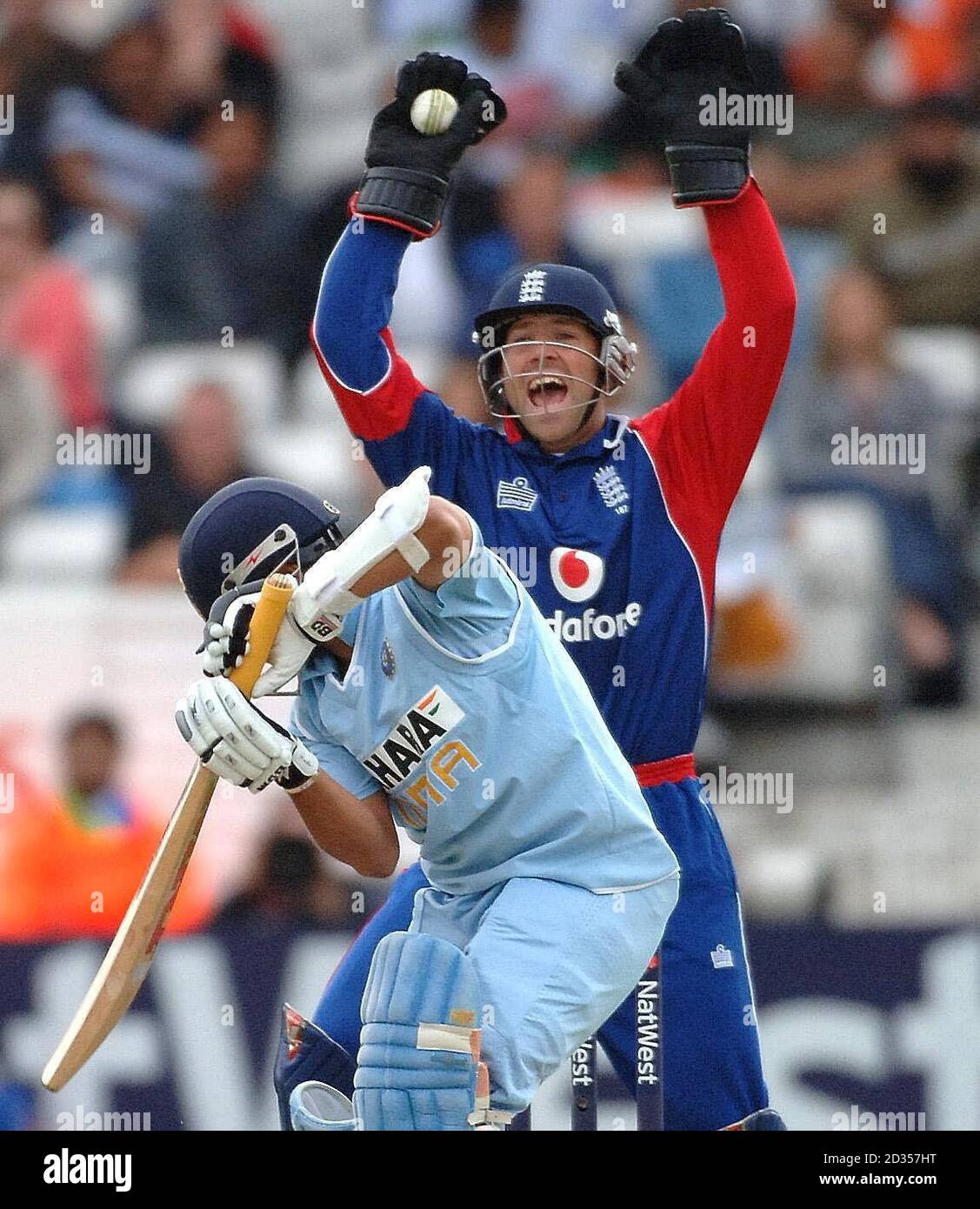 Contrasting expressions as England wicket keeper Matthew Prior shows delight and Indian batsman Sachin Tendulkar his frustration after being caught off the bowling of Jon Lewis during the Fifth NatWest One Day International at Headingley, Leeds. Stock Photo