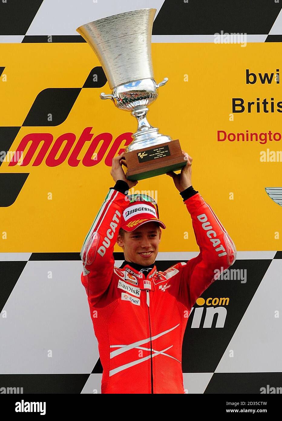 Ducati's Casey Stoner celebrates with trophy after winning the bwin.com British Motorcycle Grand Prix at Donington Park. Stock Photo