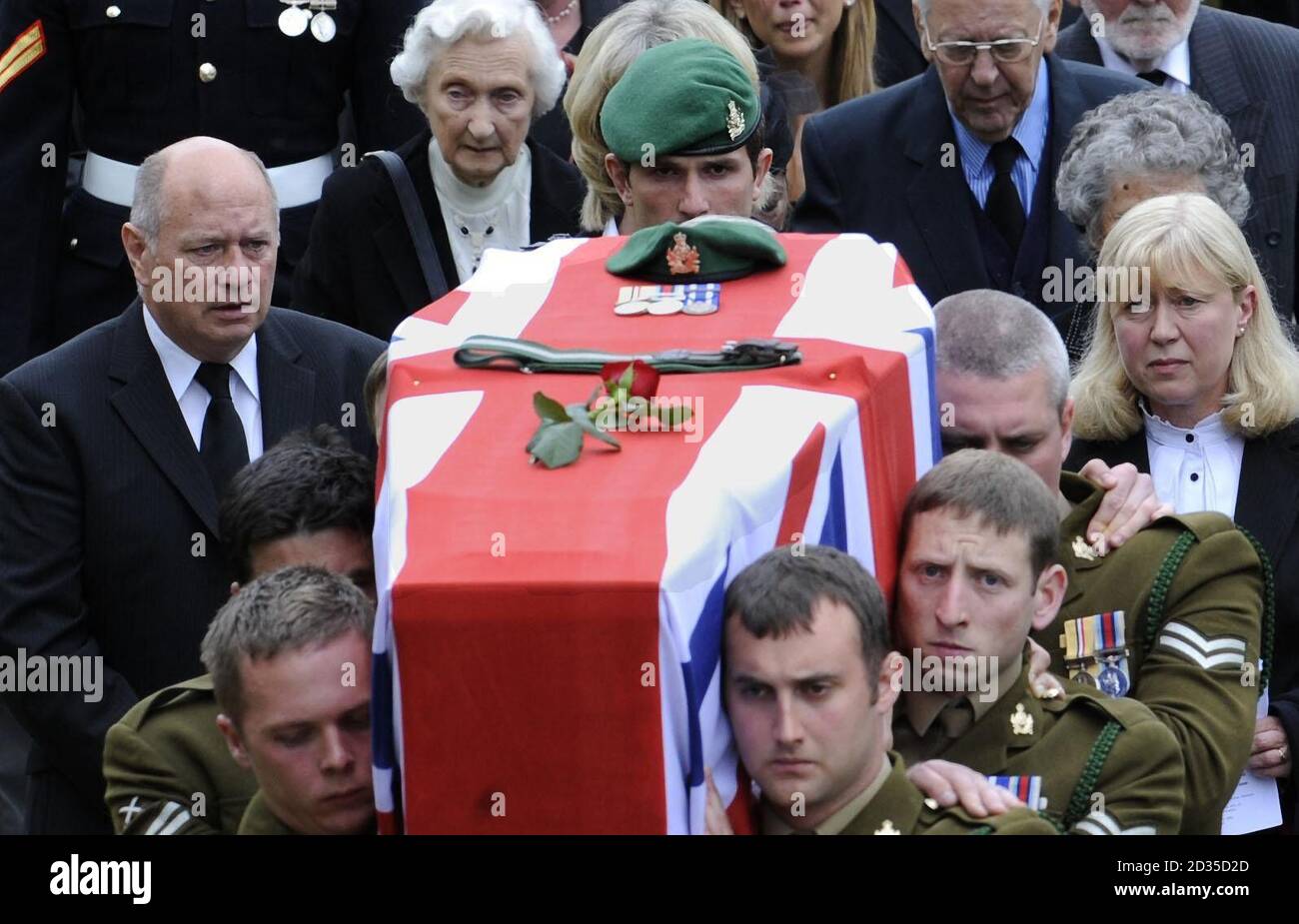 Cpl Carl Bryant (centre) is flanked by Des (left) and Maureen Feely, the parents of Corporal Sarah Bryant, as they follow her coffin at Holy Trinity Church, in Wetheral, near Carlisle, Cumbria. Stock Photo