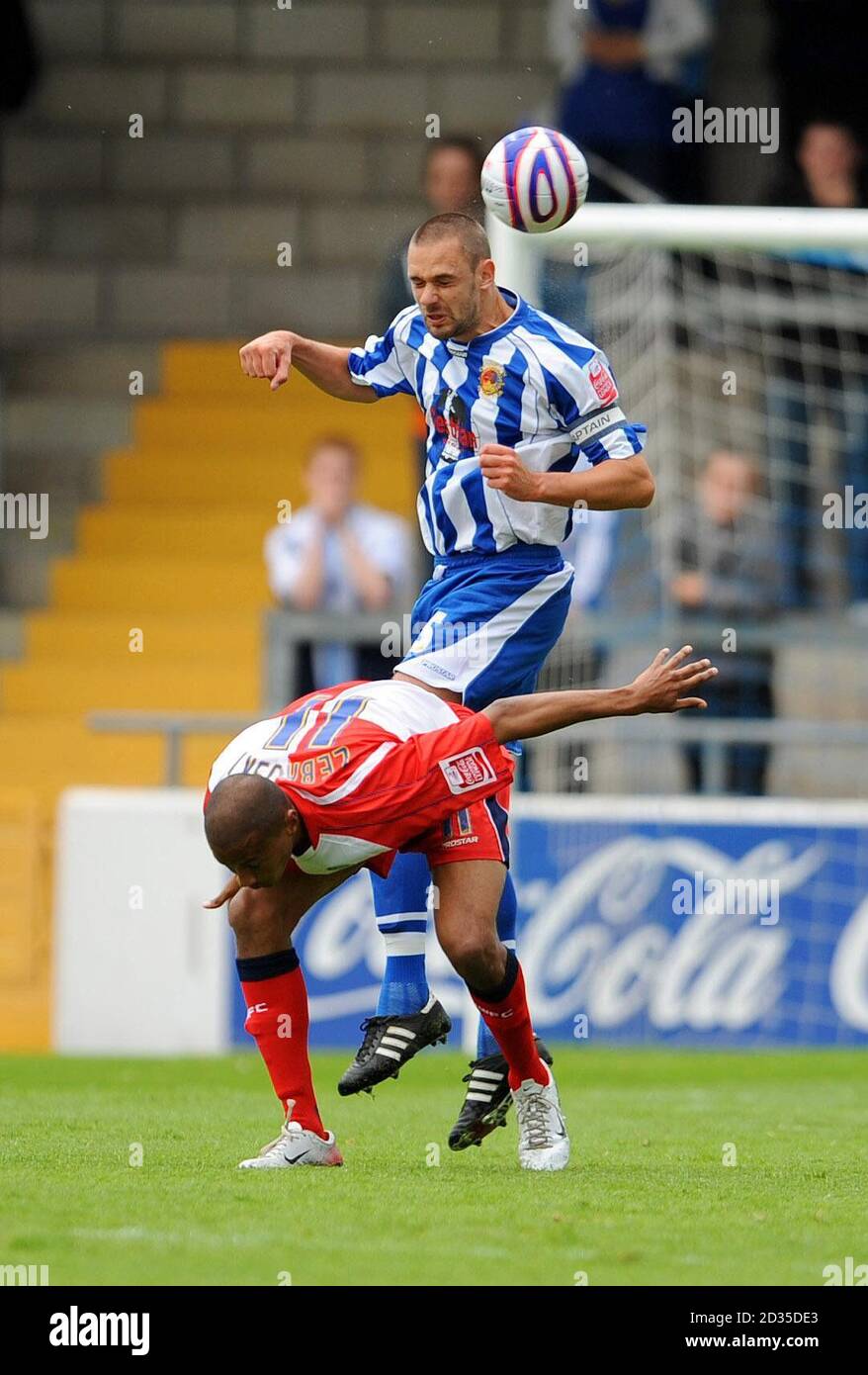 Chester's Paul Linwood wins the ball in a mid air tussle with Wycombe Wanderers' Chris Zebroski (bottom) during the Coca-Cola Football League Two match at the Deva Stadium, Chester. Stock Photo