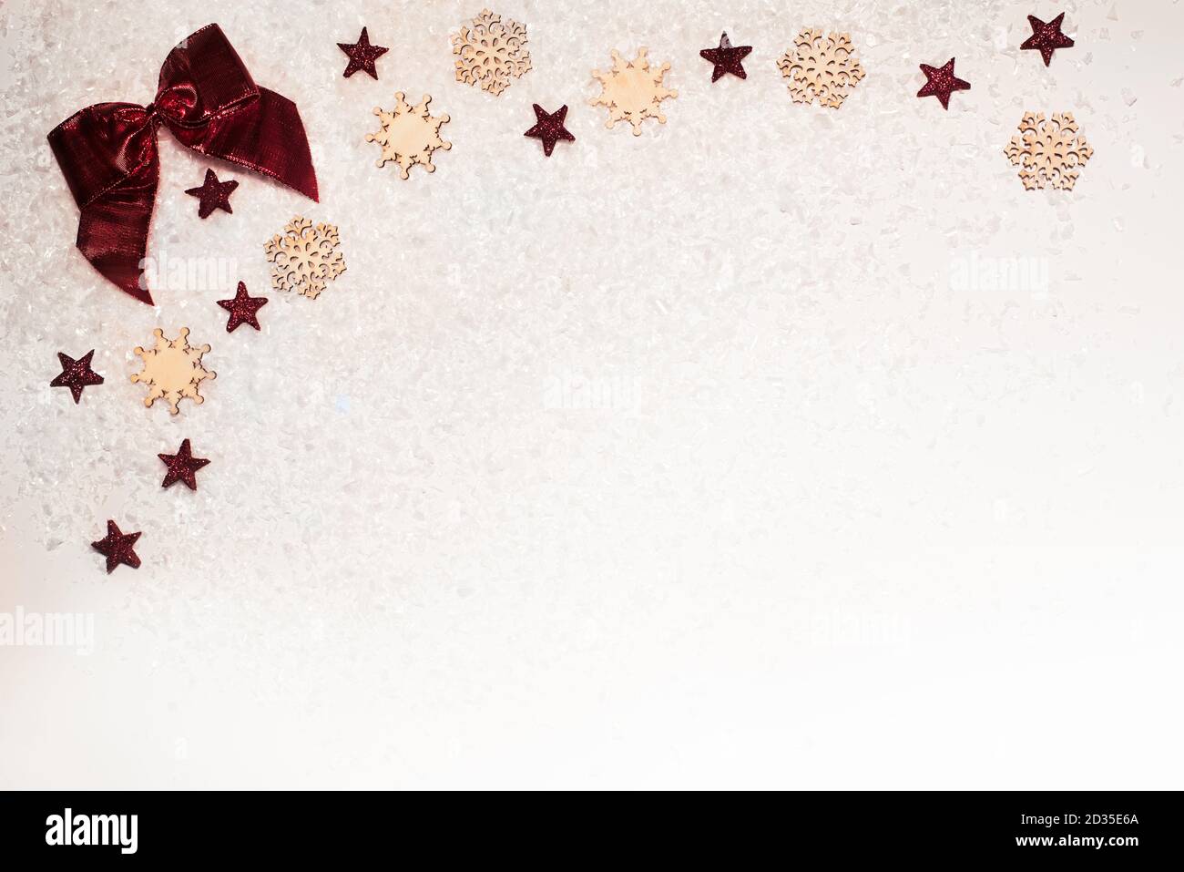 Christmas background, with glitter stars, red bow, timber snowflakes and snow - sophisticated, luxury - copy space Stock Photo