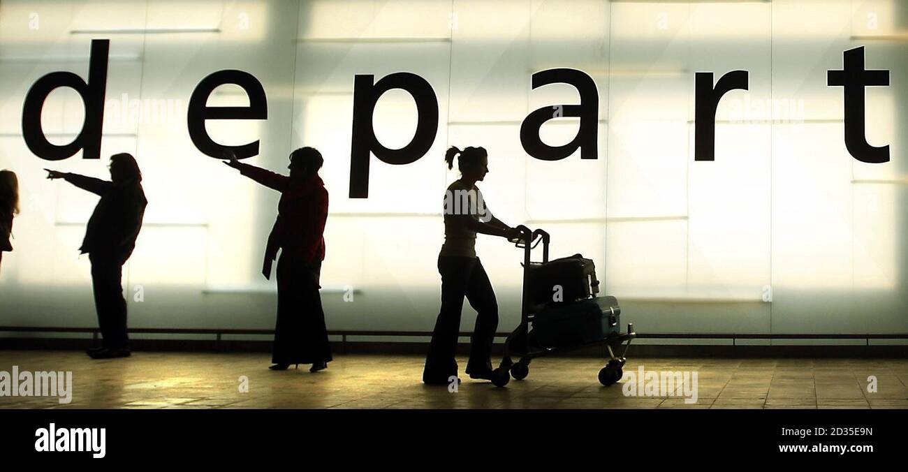 Passengers walk past a departures sign to the the new security block at Glasgow Airport, Glasgow. Stock Photo