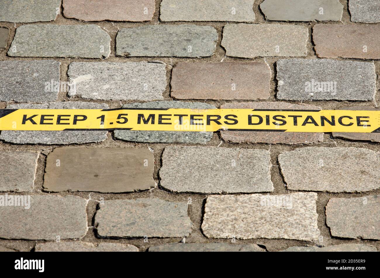 Delft, The Netherlands, October 4, 2020: yellow strips on pavement at the university campus with advice to keep 1.5 metres distance in order to preven Stock Photo