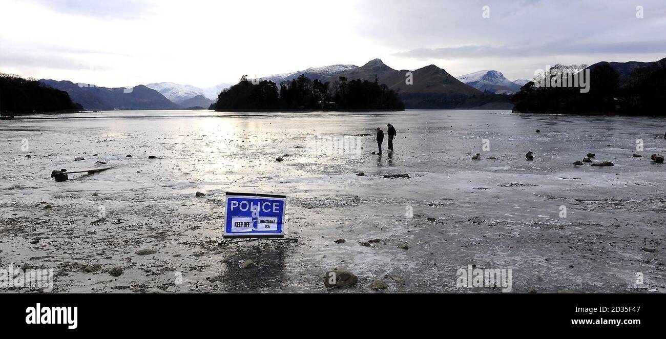 Derwentwater near Keswick frozen solid with a Police Ice warning sign today as the cold spell continues. Stock Photo