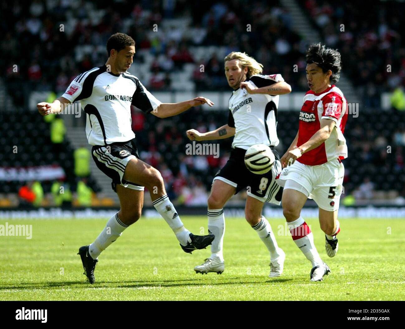 Derby County's Lewin Nyatanga and Robbie Savage battle for the ball against Charlton Athletic's Zheng Zhi during the Coca-Cola Championship match at Pride Park, Derby. Stock Photo