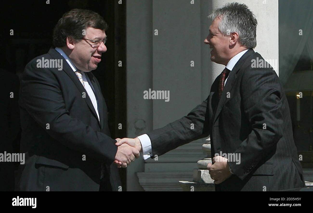 Taoiseach Brian Cowen (left) shakes hands with First Minister Peter Robinson as they arrive for the latest North South Ministerial Council meeting at Farmleigh House in Dublin. Stock Photo