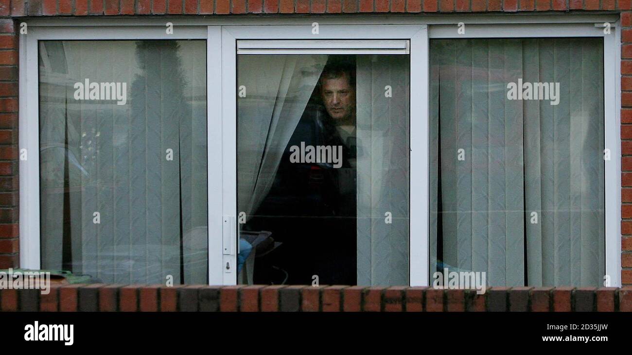 A Garda technical officer looks out of a window at the scene at Annaly Court, Ongar, in west Dublin, where four men were taken to hospital after it is believed they took liquid ecstasy during a party. Stock Photo