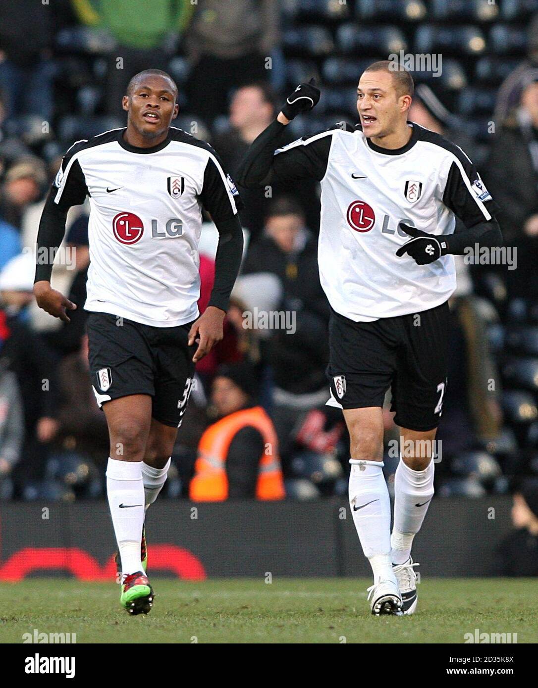 Fulham's Bobby Zamora (right) celebrates scoring his sides first goal with teammate Kagisho Evidence Dikgacoi (left) Stock Photo