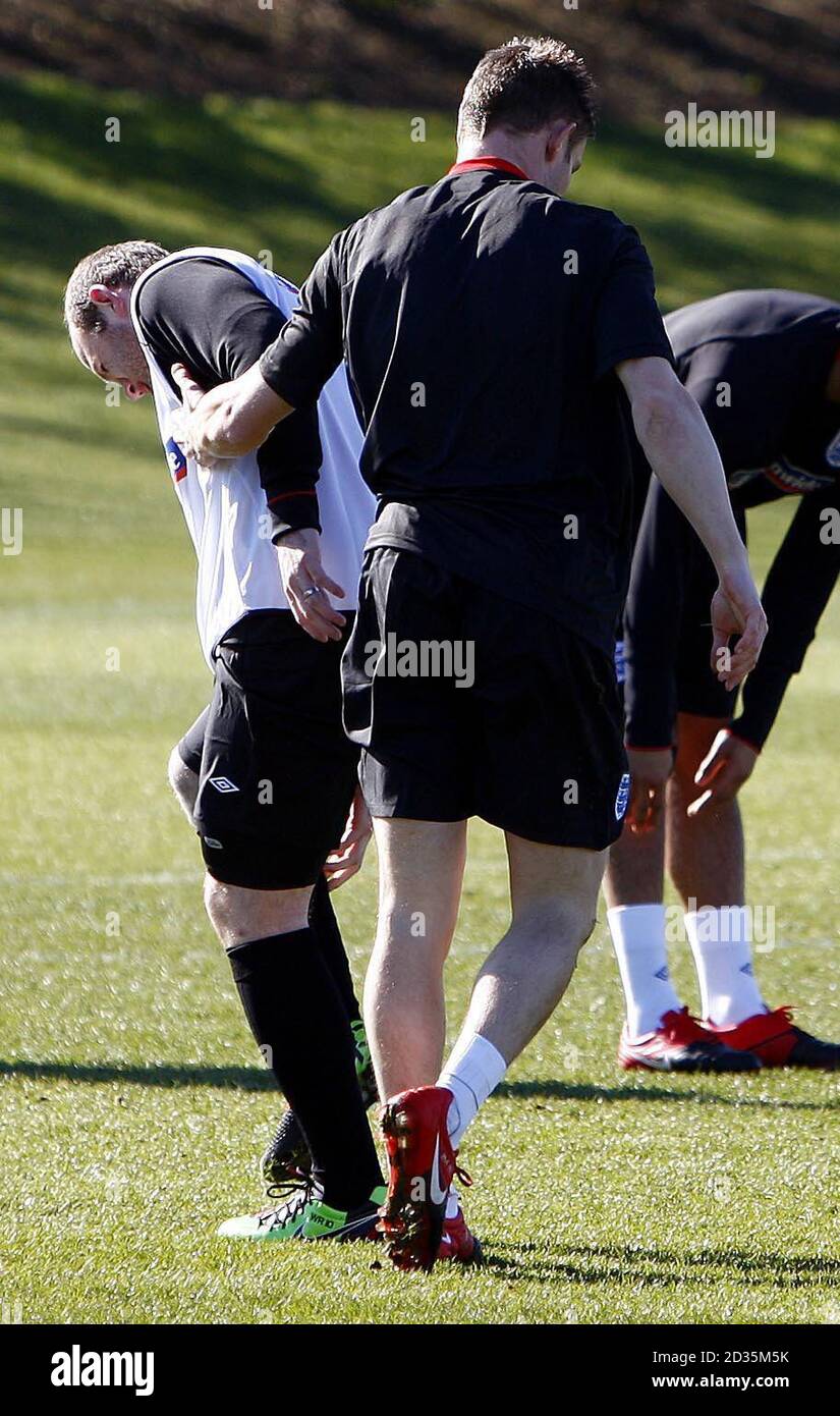 England's James Milner and Wayne Rooney (left) after clashing during the training session at London Colney, Watford. Stock Photo