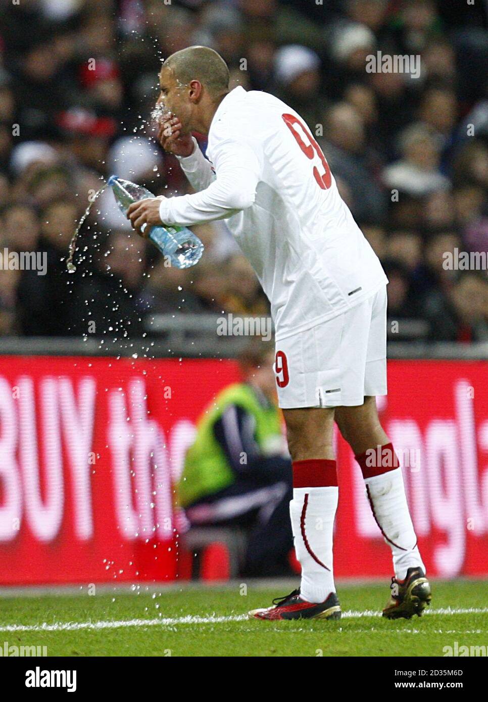 The Egypt's opening goal scorer Mohamed Zidan cools himself down with a bottle of water. Stock Photo
