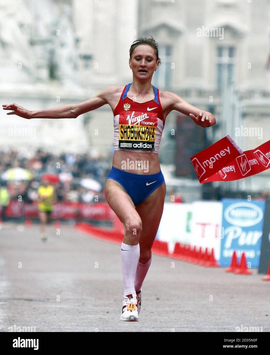 Russia's Liliya Shobukhova crosses the line to win the women's race during the 2010 Virgin London Marathon, London.  Stock Photo