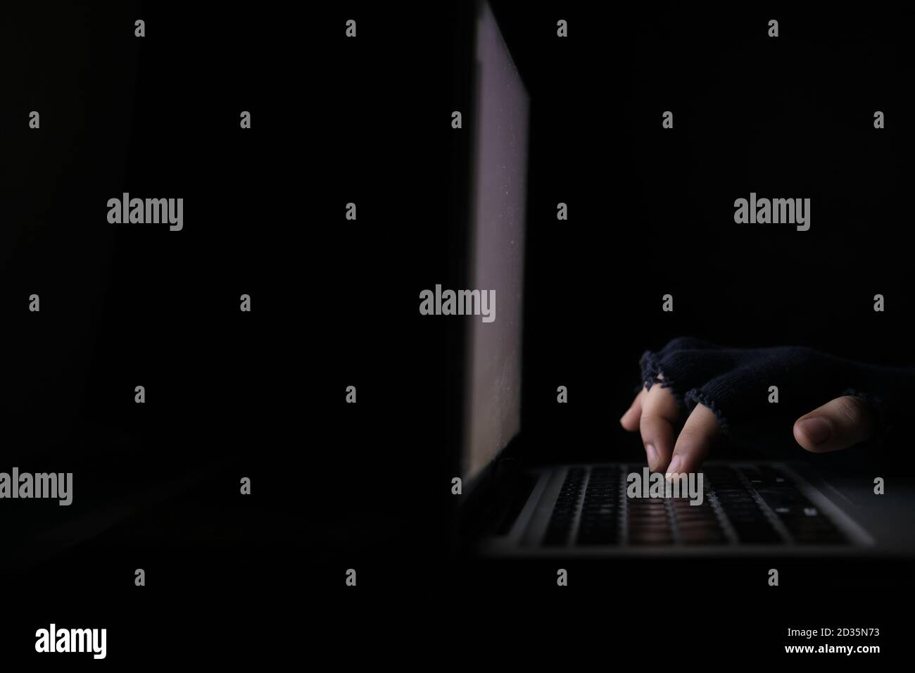 hacker hand stealing data from laptop isolated on black  Stock Photo