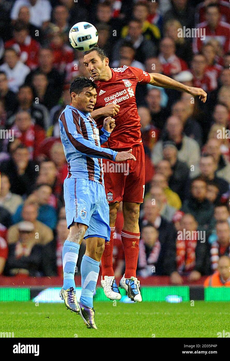 Trabzonspor's Teofilo Gutierrez (left) and Liverpool's Sotirios Kyrgiakos (right) battle for the ball in the air Stock Photo