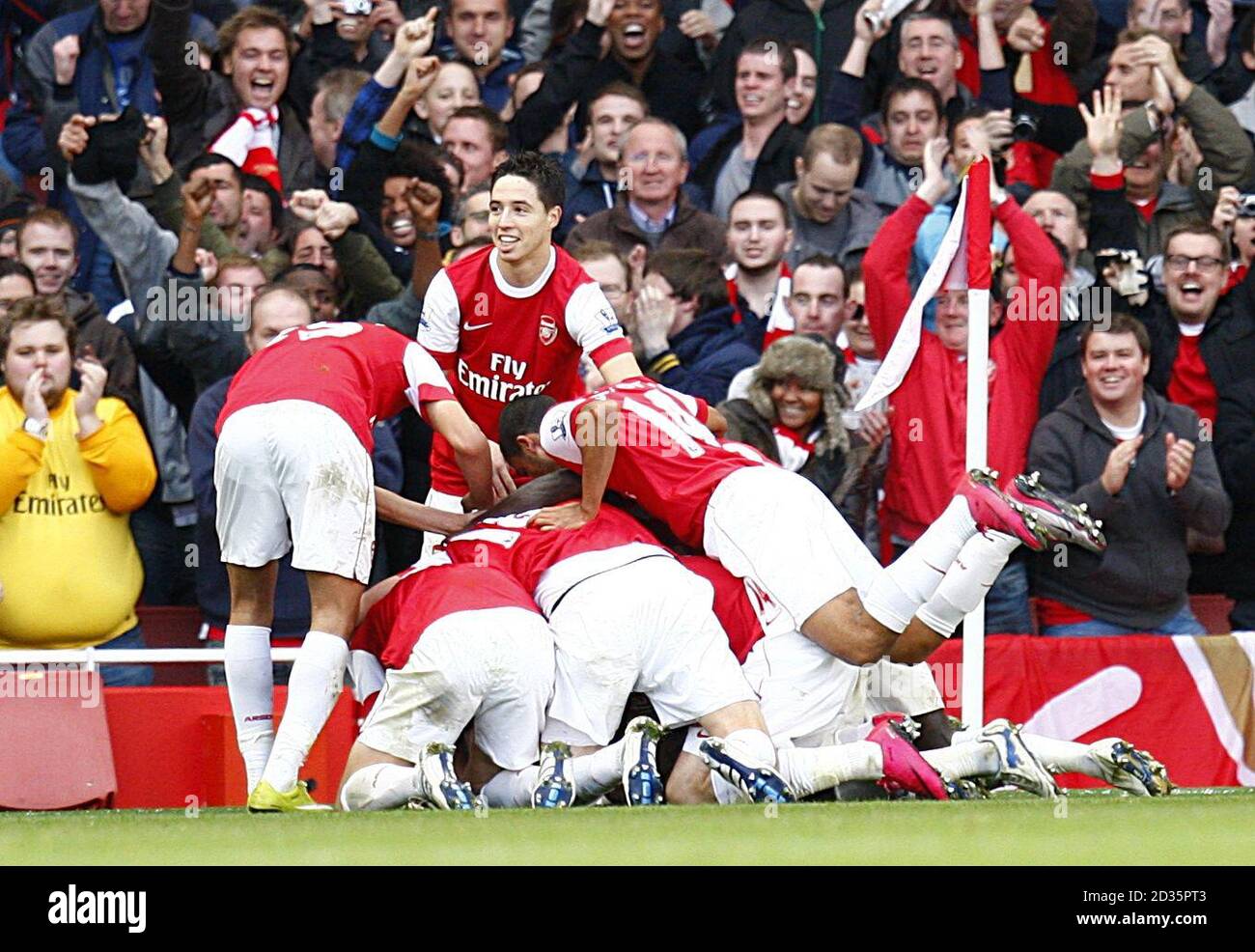 Arsenal players celebrate after their team mate Alex Song scored the only goal of the game. Stock Photo