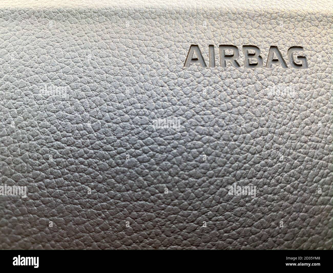 Macro of an airbag sign on a dashboard. Close up airbag sign in car