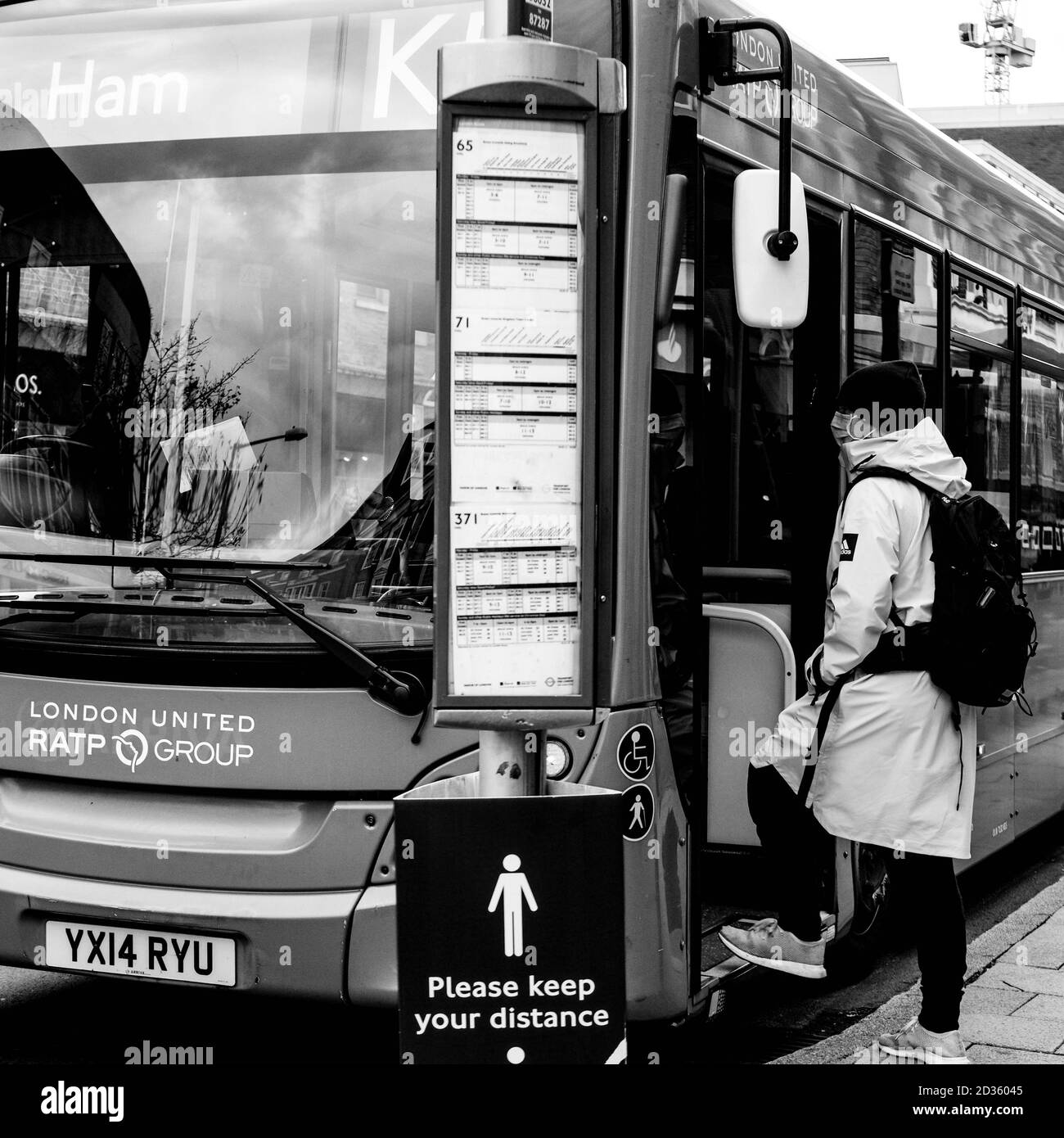 London UK October 06 2020, A Single Male Passenger Stepping Onboard A Public Transport Bus Stock Photo