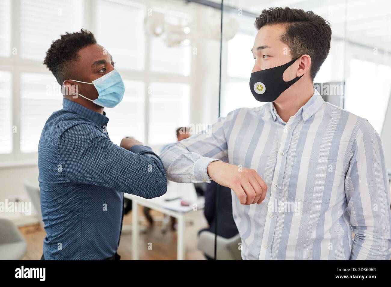 Business people when greeting with the elbow as protection against Covid-19 Stock Photo