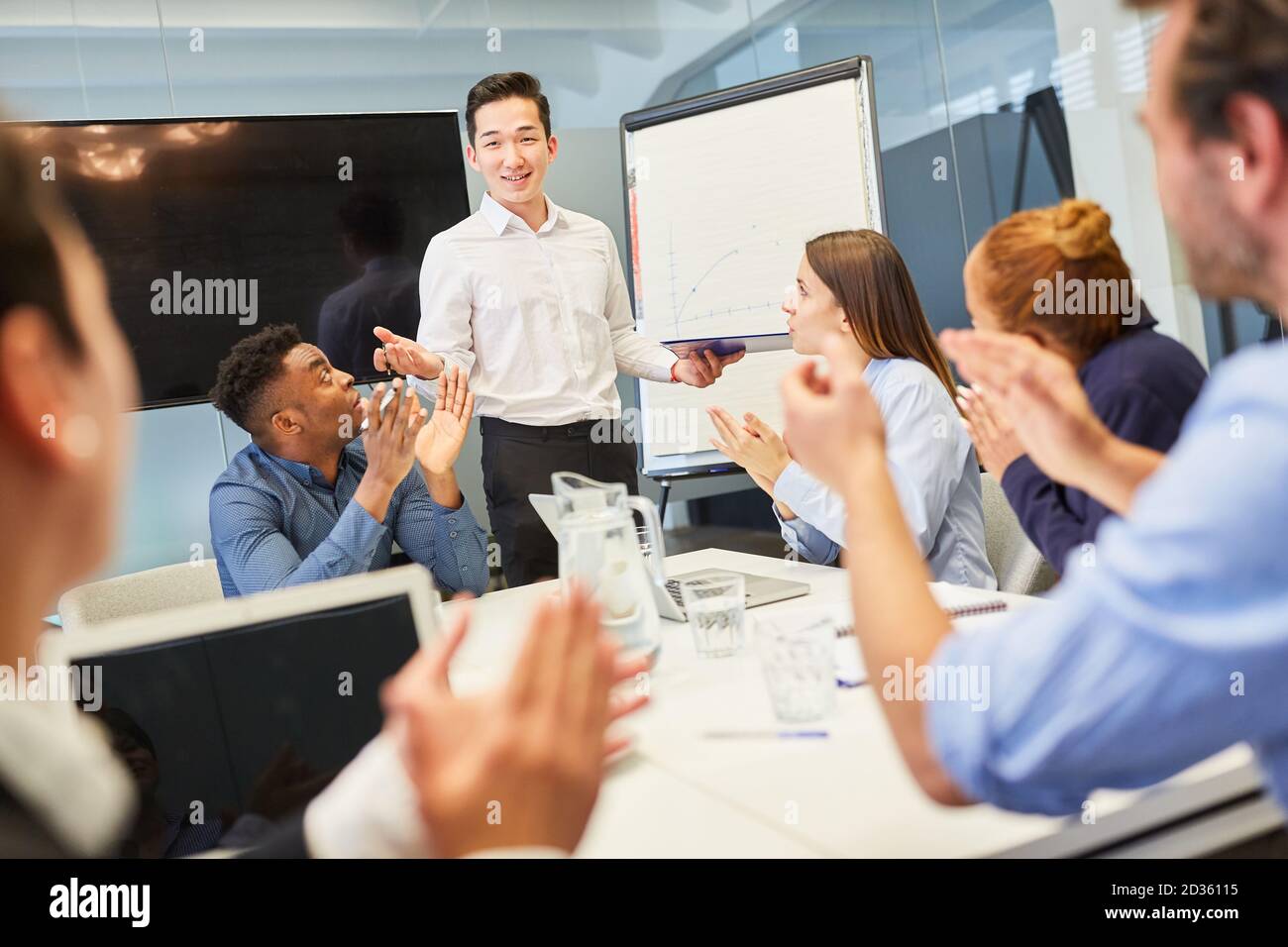 Young business man as a speaker at a presentation in a start-up meeting Stock Photo