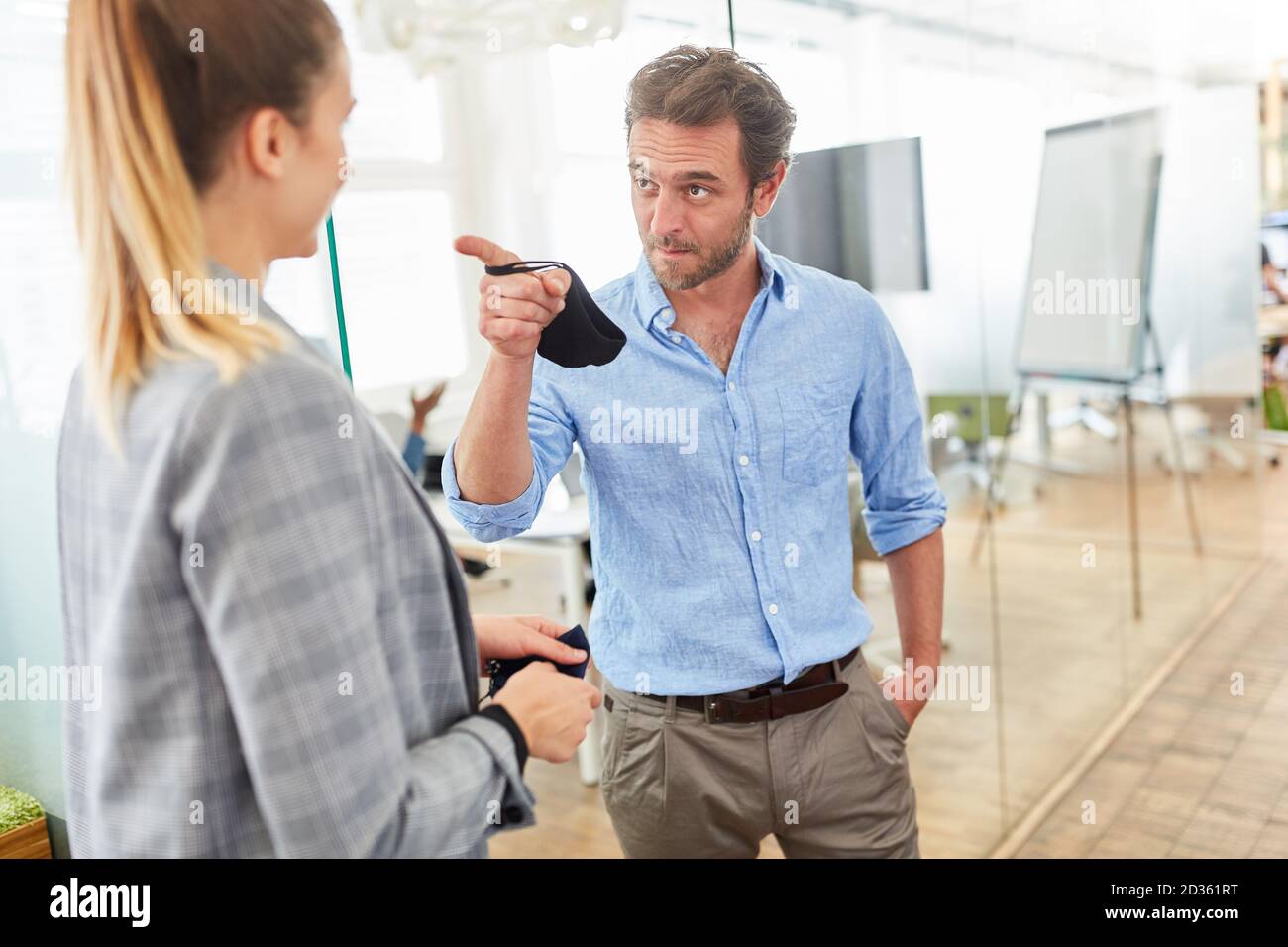 Businessman admonishes colleague with an outstretched index finger as criticism Stock Photo