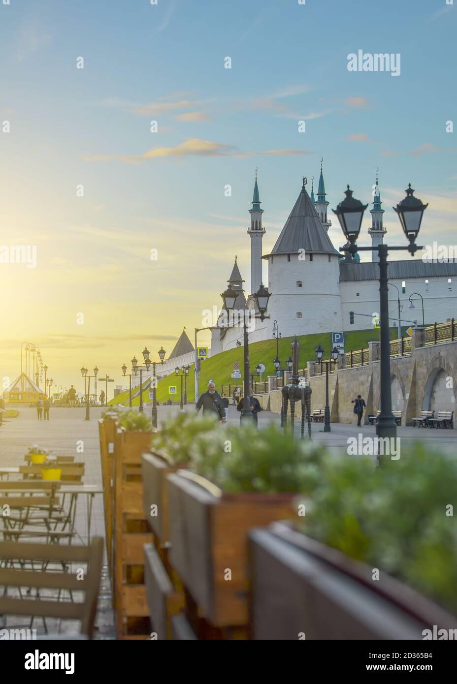 Kazan, Russia, September 14, 2020. Street cafe tables with yellow flower pots near the walls of the Kazan Kremlin in Russia, selective focus. tourist Stock Photo