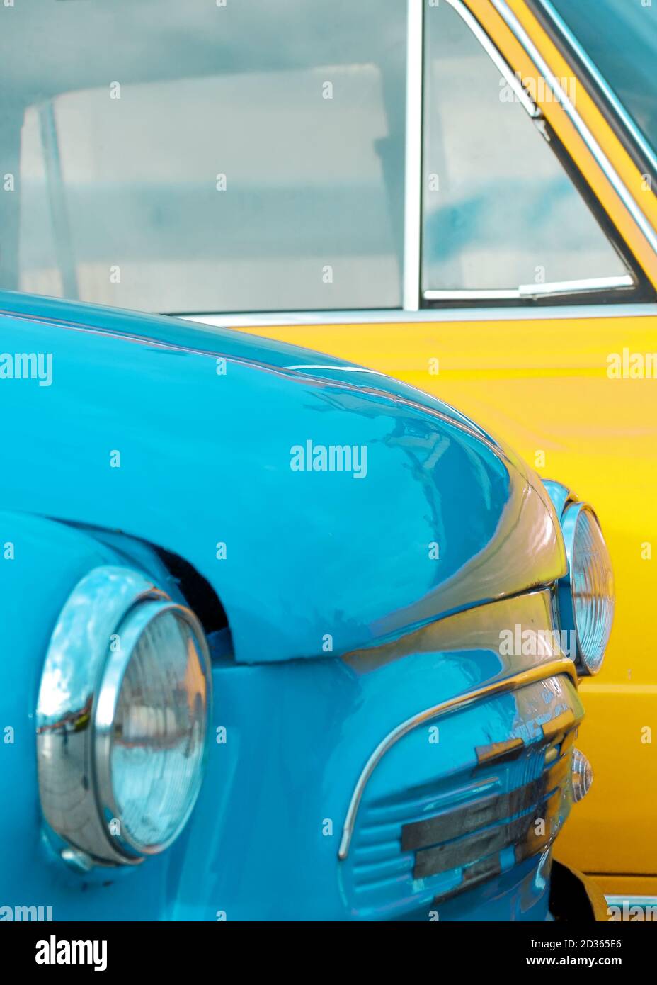 Headlights of a blue vintage car on the background of a yellow car close-up Stock Photo