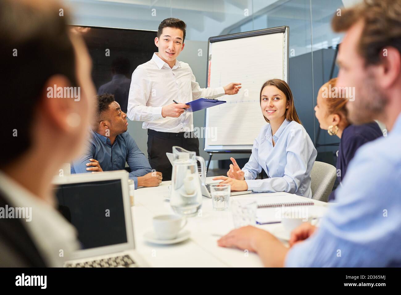 Asian businessman giving a presentation on the whiteboard Stock Photo