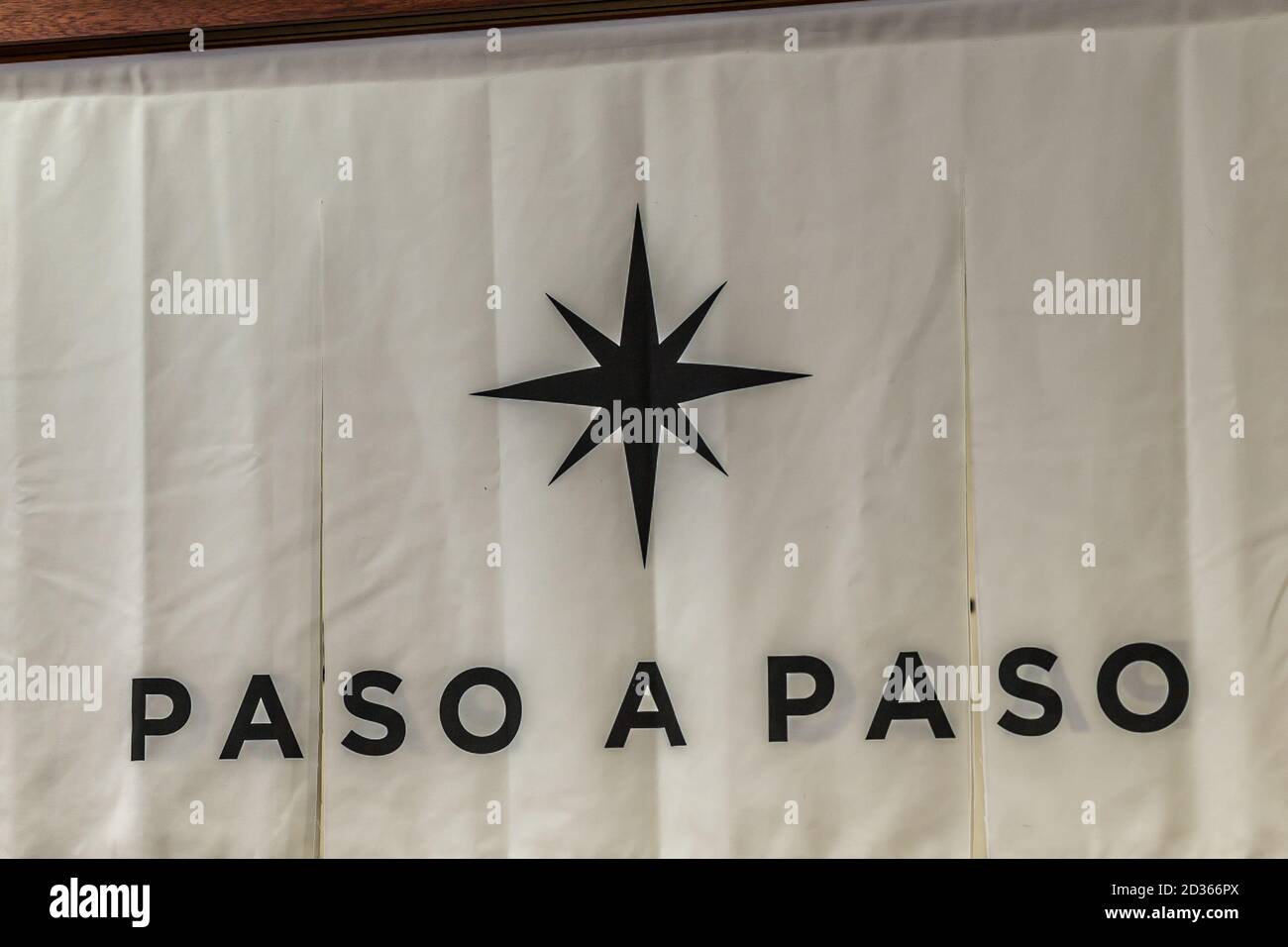 BOLOGNA (BO), ITALY - MARCH 14, 2019: light is enlightening PASO A PASO brand logo at COSMOPROF, trade show of the beauty industry Stock Photo