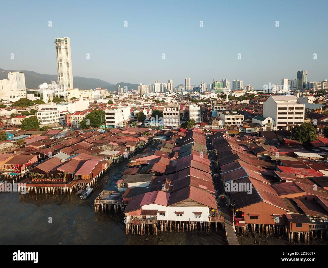 Georgetown, Penang/Malaysia - Feb 29 2020: Wooden house at sea clan jetty. Background is KOMTAR tower. Stock Photo
