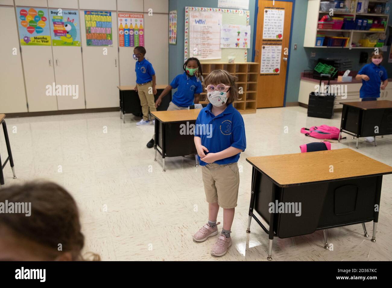 Austin, TX USA October 6, 2020: Kindergarten students stand by their widely-spaced desks as they return to the classroom for the first time since March at Campbell Elementary in Austin. The public school is using a combination of remote and in-person learning in the age of coronavirus. Credit: Bob Daemmrich/Alamy Live News Stock Photo