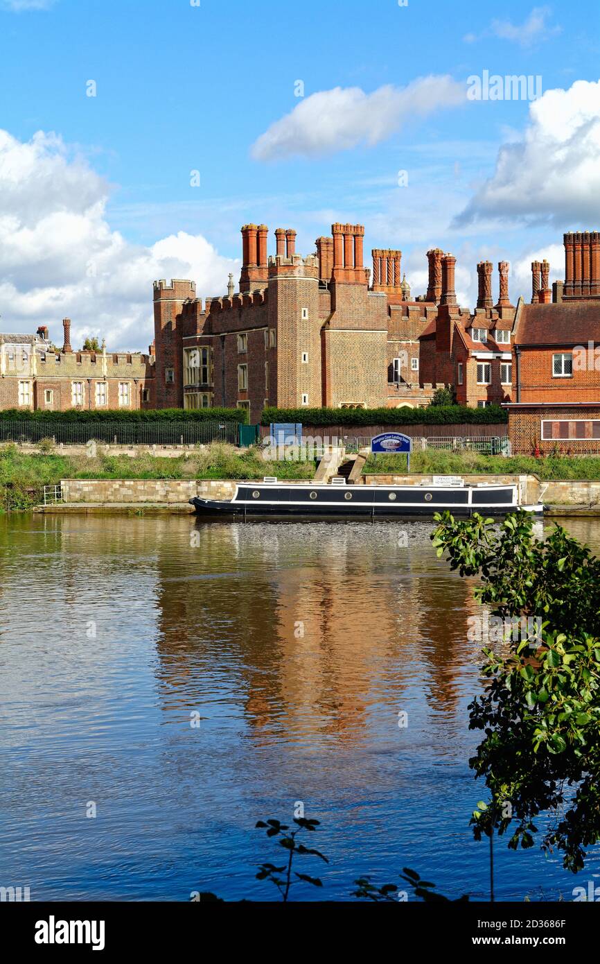 Exterior of the Royal Palace of Hampton Court with the River Thames in the foreground, on a sunny autumn day, west London England UK Stock Photo