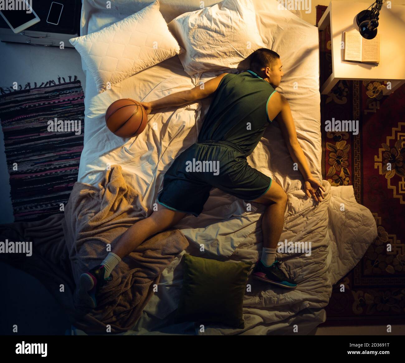 Attack. Top view of young professional basketball player sleeping at